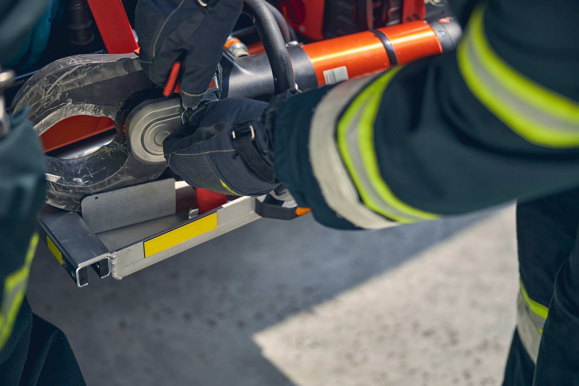 Firefighter is installing equipment on the fire truck